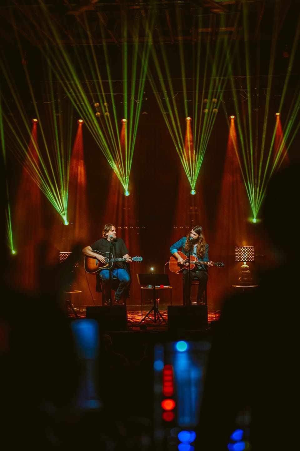 Brent Cobb. Two musicians sit on stage with green laser beams fanning out above them.