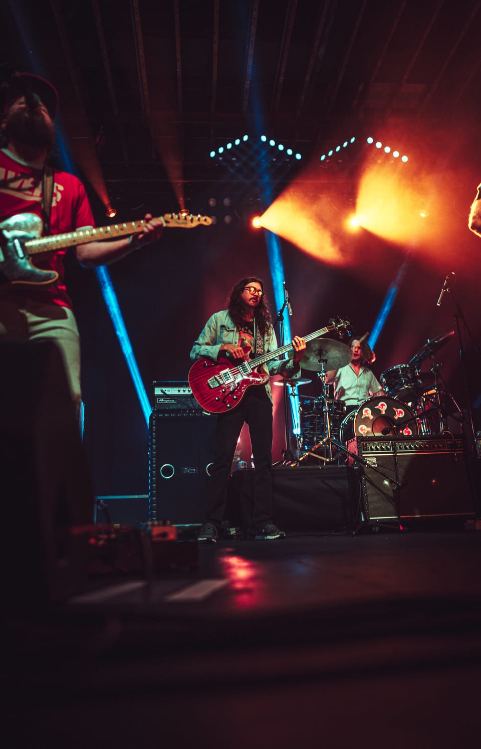 Future Birds. A band on a distant stage framed by red and white lights.